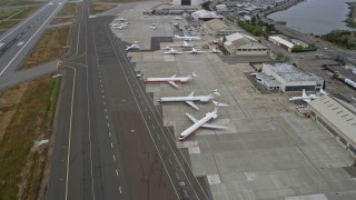 6K aerial stock footage of commercial and private jets at Oakland Airport, California Aerial Stock Footage | AX0175_0223