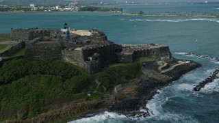 4.8K aerial stock footage of a Historic fort along the coast with clear blue water, Old San Juan Puerto Rico Aerial Stock Footage | AX101_011E