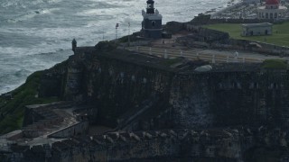 4.8K aerial stock footage of a Historic fort and lighthouse on the coast, Old San Juan Puerto Rico Aerial Stock Footage | AX101_021E