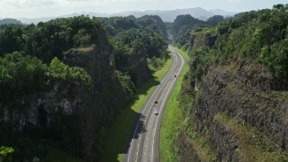 4.8K aerial stock footage Tilting up on a highway through lush green mountains, Karst Forest, Puerto Rico Aerial Stock Footage | AX101_083E