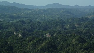 4.8K aerial stock footage of Limestone cliffs among lush green Karst Forest, Puerto Rico Aerial Stock Footage | AX101_088E