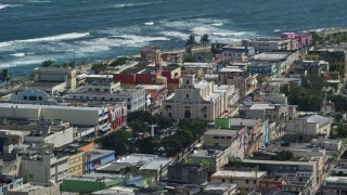 4.8K aerial stock footage of the Catedral San Felipe among buildings along the coast, Arecibo Puerto Rico Aerial Stock Footage | AX101_137