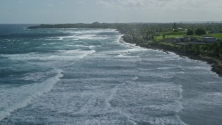 4.8K aerial stock footage flying over blue water along the coast and oceanfront property, Arecibo, Puerto Rico Aerial Stock Footage | AX101_157E