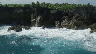 4.8K aerial stock footage of Coastal rock formations and caves on clear blue water, Arecibo, Puerto Rico  Aerial Stock Footage | AX101_163