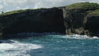 4.8K aerial stock footage of coastal sea cave in rock formations, Arecibo, Puerto Rico Aerial Stock Footage | AX101_165E