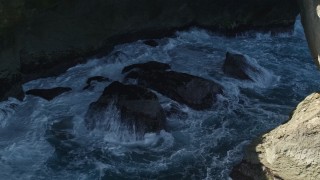 4.8K aerial stock footage of Churning water in a sea cave, Arecibo, Puerto Rico Aerial Stock Footage | AX101_167