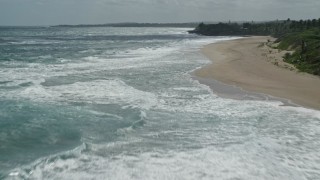 4.8K aerial stock footage of clear blue water along a beach, Arecibo, Puerto Rico Aerial Stock Footage | AX101_174E