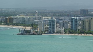 4.8K aerial stock footage of Apartment buildings on the coast and crystal blue waters, Carolina, Puerto Rico  Aerial Stock Footage | AX102_008