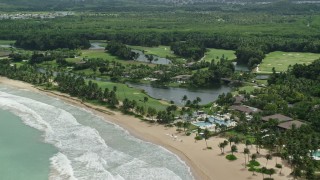 4.8K aerial stock footage of turquoise waters along the beach approaching a resort, Rio Grande, Puerto Rico Aerial Stock Footage | AX102_039E