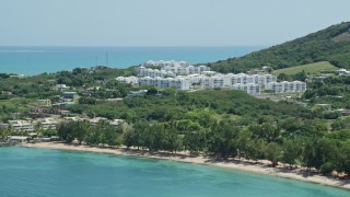 AX102_059 - 4.8K aerial stock footage of The Ocean Club at Seven Seas seen from the beach, Fajardo, Puerto Rico 