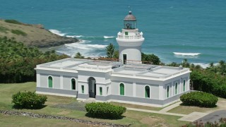 AX102_064E - 4.8K aerial stock footage orbiting Cape San Juan Light, Puerto Rico