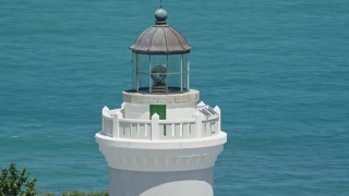 4.8K aerial stock footage Orbiting the top of Cape San Juan Light with views of clear blue waters, Puerto Rico Aerial Stock Footage | AX102_070