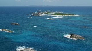 4.8K aerial stock footage of a tiny island in tropical blue waters, Puerto Rico Aerial Stock Footage | AX102_087E