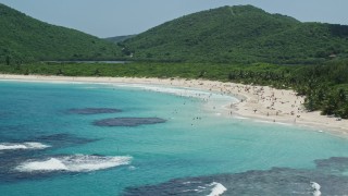 AX102_112 - 4.8K aerial stock footage of Beachgoers on white sand Caribbean Flamenco Beach along sapphire blue waters, Culebra, Puerto Rico 