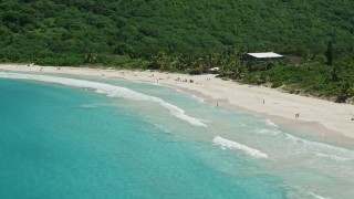 4.8K aerial stock footage of Sapphire blue waters and beachgoers on white sand Caribbean Flamenco Beach, Culebra, Puerto Rico  Aerial Stock Footage | AX102_113