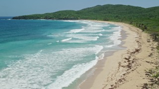 AX102_122E - 4.8K aerial stock footage of coastal vegetation along a deserted Caribbean beach and sapphire blue waters, Culebra, Puerto Rico