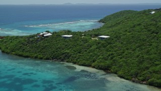 4.8K aerial stock footage of Oceanfront homes nestled among trees along sapphire blue waters, Culebra, Puerto Rico  Aerial Stock Footage | AX102_137