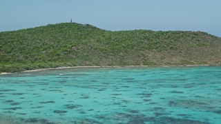 AX102_174E - 4.8K aerial stock footage of sapphire blue waters along an island, Culebrita, Puerto Rico