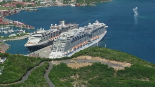 4.8K aerial stock footage of a Docked cruise ship in a coastal town in sapphire waters, Charlotte Amalie, St. Thomas Aerial Stock Footage | AX102_199