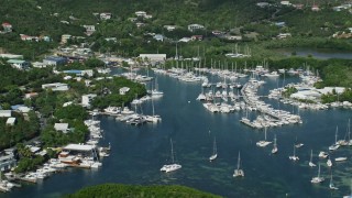 4.8K aerial stock footage of a marina with boats in blue ocean waters, Benner Bay, St Thomas Aerial Stock Footage | AX102_238E