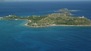 4.8K aerial stock footage of Little St James Island surrounded by sapphire waters, St Thomas, US Virgin Islands Aerial Stock Footage | AX102_248E