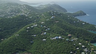 4.8K aerial stock footage of Hilltop homes over looking the blue ocean waters, East End, St Thomas  Aerial Stock Footage | AX102_259