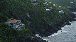 AX102_266 - 4.8K aerial stock footage of an Oceanfront mansion on a cliff, Northside, St Thomas 