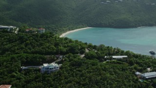 AX102_268 - 4.8K aerial stock footage of a Caribbean beach along turquoise blue waters, Magens Bay, St Thomas 