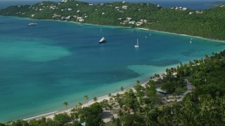 4.8K aerial stock footage of white sand Caribbean beach along turquoise blue waters with sailboats, Magens Bay, St Thomas Aerial Stock Footage | AX102_272E