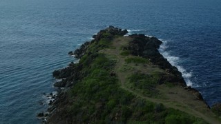 AX102_276E - 4.8K aerial stock footage of hillside oceanfront homes along sapphire blue Caribbean waters, Magens Bay, St Thomas