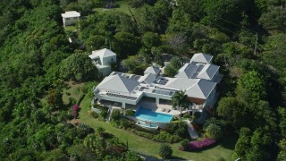 4.8K aerial stock footage of a Mansion nestled among trees, Charlotte Amalie, St Thomas  Aerial Stock Footage | AX102_298