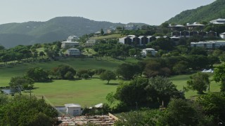 4.8K aerial stock footage of University of the Virgin Islands set among tree covered hillside, St Thomas Aerial Stock Footage | AX102_306