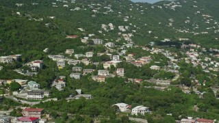 AX103_003 - 4.8K aerial stock footage of Upscale hillside homes among trees, Charlotte Amalie, St Thomas