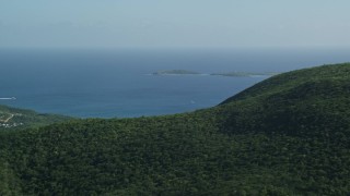 4.8K aerial stock footage of tree-covered hills above blue Caribbean waters, Southside, St Thomas Aerial Stock Footage | AX103_009E