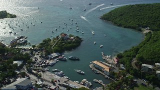 4.8K aerial stock footage of a fort and harbor with boats in turquoise blue Caribbean waters, Cruz Bay, St John Aerial Stock Footage | AX103_021E