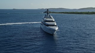 AX103_025E - 4.8K aerial stock footage of a yacht in sun-kissed Caribbean waters among small islands, Cruz Bay, St John