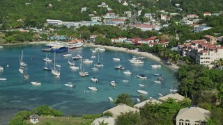 AX103_029E - 4.8K aerial stock footage of the blue Caribbean waters in the harbor and hillside homes, Cruz Bay, St John