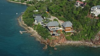 4.8K aerial stock footage of an Oceanfront mansion along turquoise blue Caribbean waters, Cruz Bay, St John Aerial Stock Footage | AX103_034