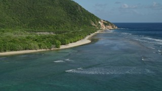 4.8K aerial stock footage of a Caribbean beach along jungle and sapphire blue Caribbean waters, Reef Bay, St John Aerial Stock Footage | AX103_046