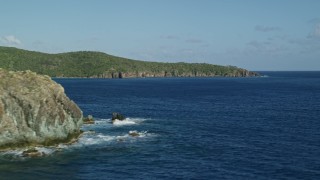 4.8K aerial stock footage of coastal cliffs along sapphire blue Caribbean waters, Central, St John Aerial Stock Footage | AX103_050E