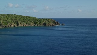 4.8K aerial stock footage of a Tree covered rugged coast along blue waters of Great Lameshur Bay, St John Aerial Stock Footage | AX103_056