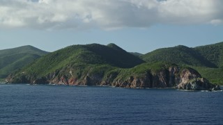 4.8K aerial stock footage of Coastal cliffs and jungle along sapphire blue Caribbean waters, Central, St John Aerial Stock Footage | AX103_057