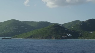 AX103_058 - 4.8K aerial stock footage of Hillside mansions along Caribbean blue waters, Cruz Bay, St John