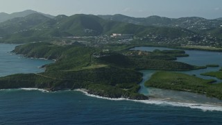 4.8K aerial stock footage of tiny islands in sapphire blue Caribbean waters along the shores, East End, St Thomas Aerial Stock Footage | AX103_064E