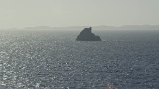 4.8K aerial stock footage of a Rock formation in sparkling blue Caribbean waters, St Thomas Aerial Stock Footage | AX103_078E