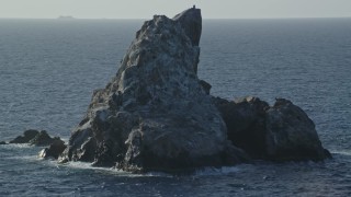 4.8K aerial stock footage of a rock formation in sparkling Caribbean waters, St Thomas Aerial Stock Footage | AX103_080E