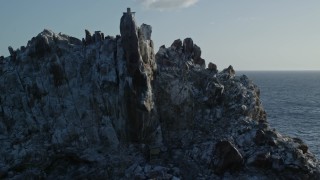 4.8K aerial stock footage of circling a rock formation in Caribbean blue waters, St Thomas Aerial Stock Footage | AX103_082E