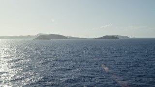 AX103_087 - 4.8K aerial stock footage Flying over sapphire blue Caribbean waters approaching an island, Culebrita, Puerto Rico