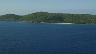 4.8K aerial stock footage of Vegetation covered island along sapphire blue Caribbean waters, Cayo Norte, Puerto Rico Aerial Stock Footage | AX103_095