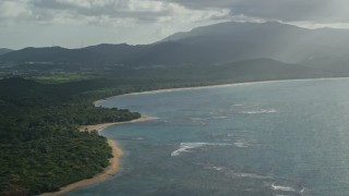 4.8K aerial stock footage of a Caribbean beach and jungle along turquoise blue waters, Fajardo, Puerto Rico Aerial Stock Footage | AX103_118